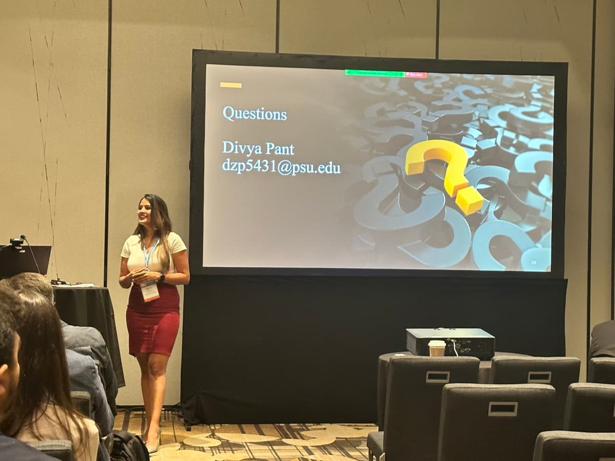 Divya presenting at an academic conference